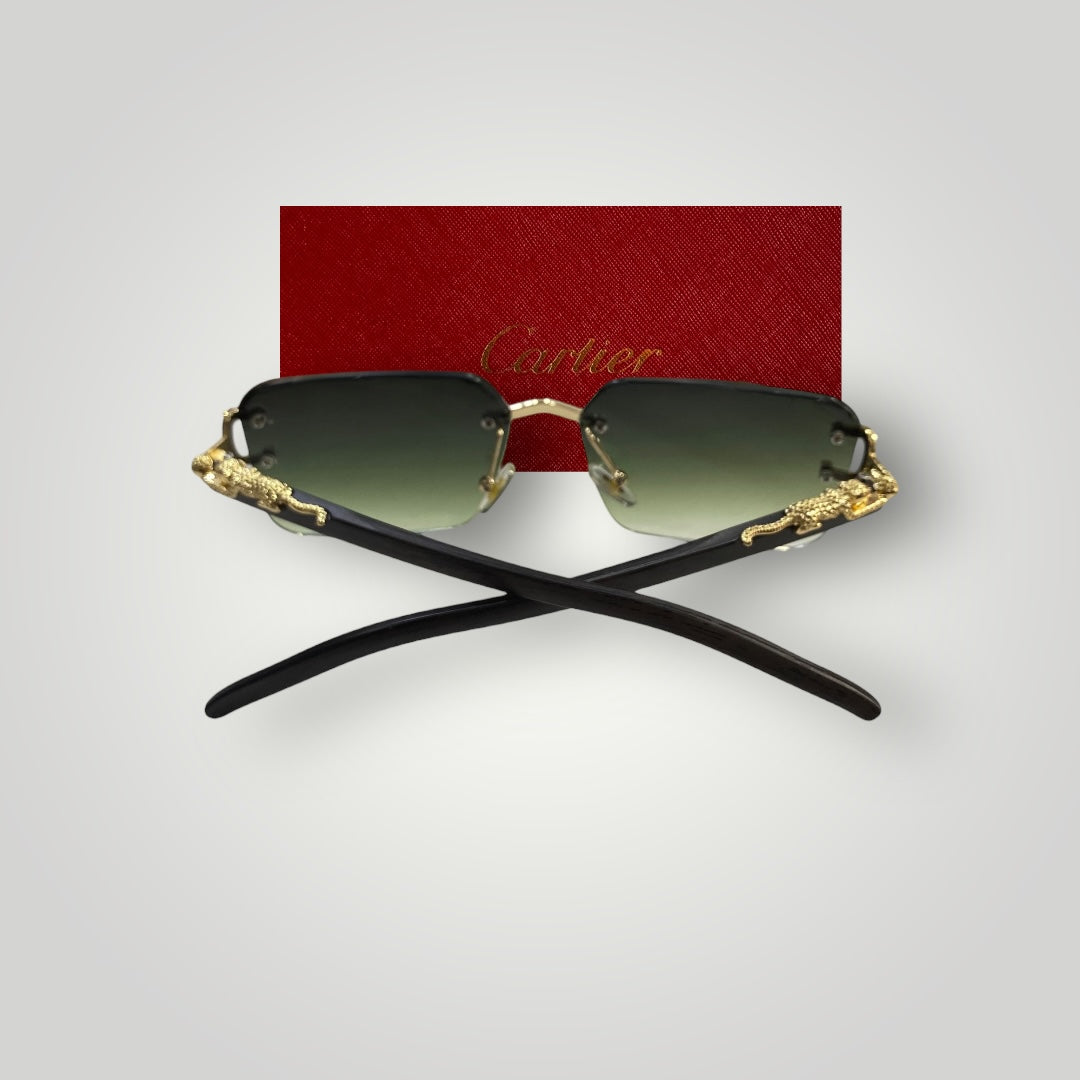 Side profile of luxury rimless sunglasses showing black temple arms with gold accents and green gradient lenses