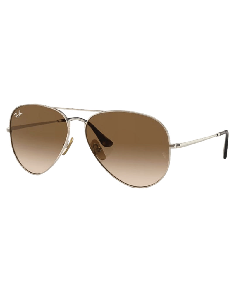 Angled view of Ray-Ban aviator sunglasses highlighting silver metal frame and brown gradient lenses