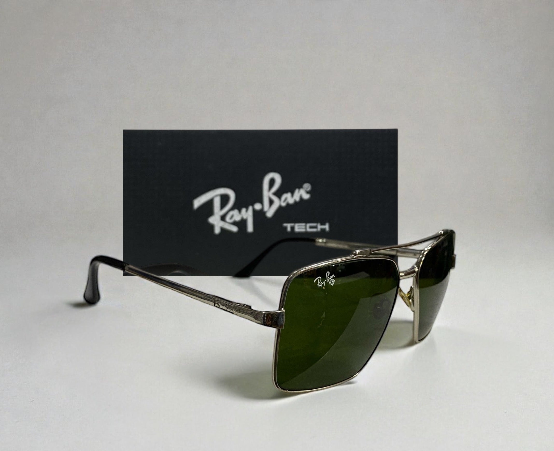 Ray-Ban Tech square sunglasses with green lenses and metal frame angled with Ray-Ban Tech box in background
