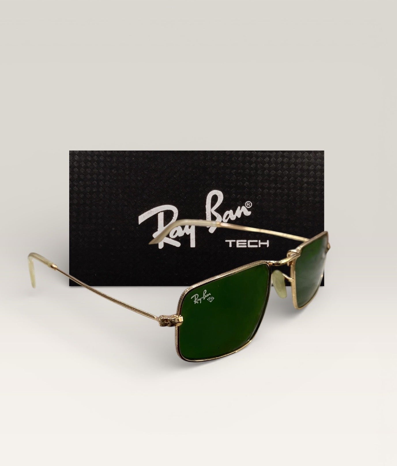 Ray-Ban Tech sunglasses with rectangular green lenses and gold metal frame angled left with black Ray-Ban TECH branded background