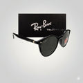 Side angled view of Ray-Ban polarized sunglasses with black acetate frame and dark lenses, positioned in front of a Ray-Ban Tech black textured box.