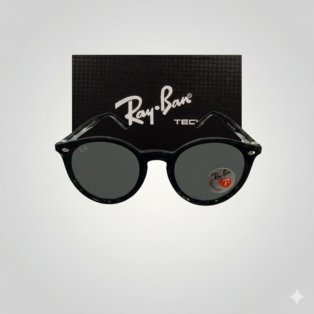 Front view of Ray-Ban polarized sunglasses featuring round black acetate frames and dark polarized lenses, with Ray-Ban Tech branding on the box behind.