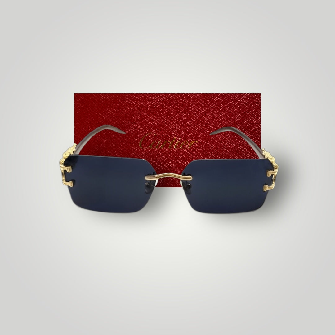 Front view of luxury rimless sunglasses with white bridge and blue rectangular lenses set against red Cartier case