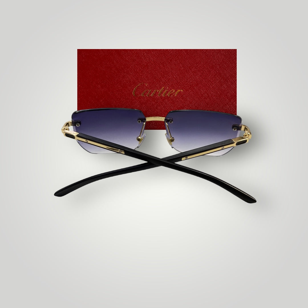 Back view of Cartier rimless sunglasses showing black temples with gold accents crossed over in front of Cartier red box