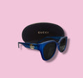Beenai Original 3005 men's blue acetate sunglasses with gold GG logo and black Gucci case on pink background
